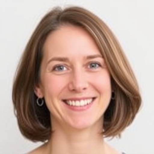A headshot of a smiling woman with short brown hair.